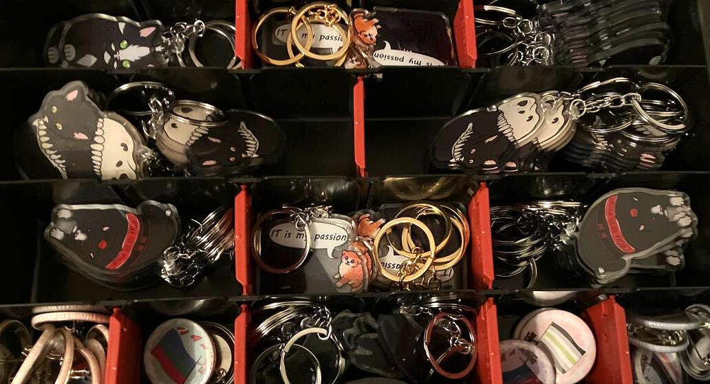 Box full of Keycharms and Button Pins